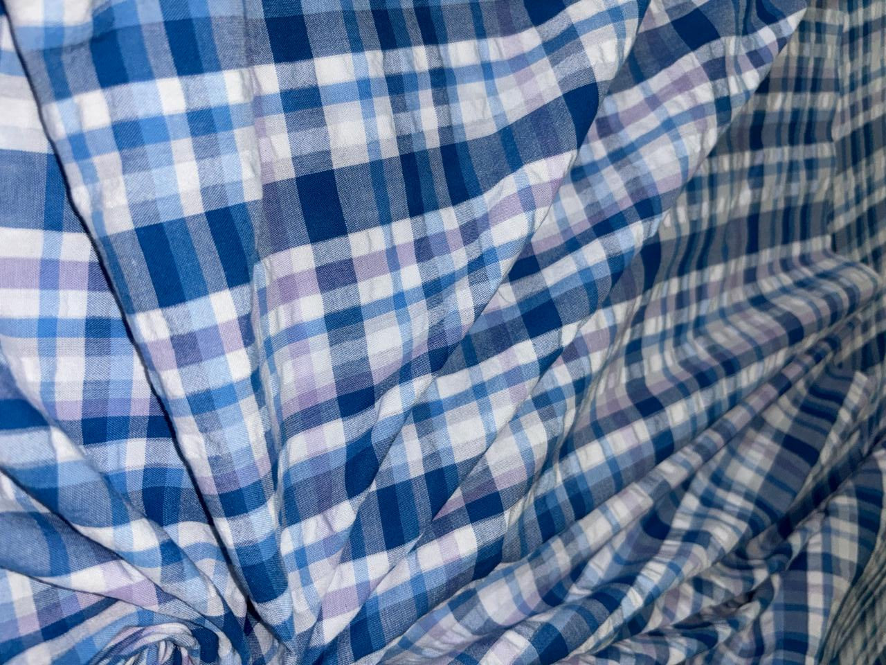 100 % cotton seersucker yarn dyed American plaids  manufactured  by Arvind mills, 58 inches wide /147 cms,available in 2 colors BLUES /PURPLES AND WHITE and  BLUEISH GREY/GREY/PINKS AND WHITE IVORY