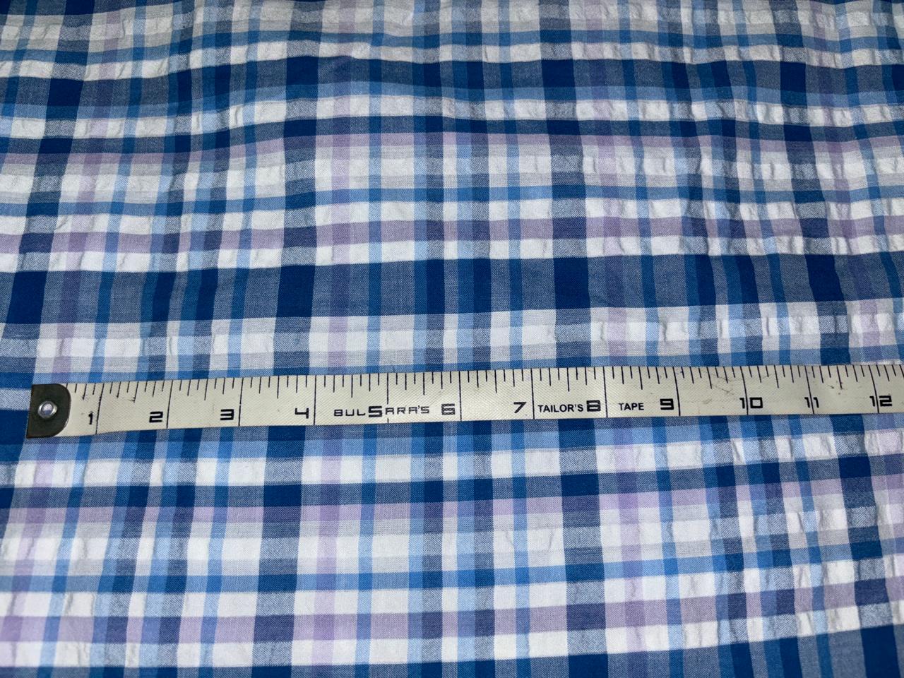 100 % cotton seersucker yarn dyed American plaids  manufactured  by Arvind mills, 58 inches wide /147 cms,available in 2 colors BLUES /PURPLES AND WHITE and  BLUEISH GREY/GREY/PINKS AND WHITE IVORY